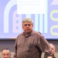 person standing at table photo 2